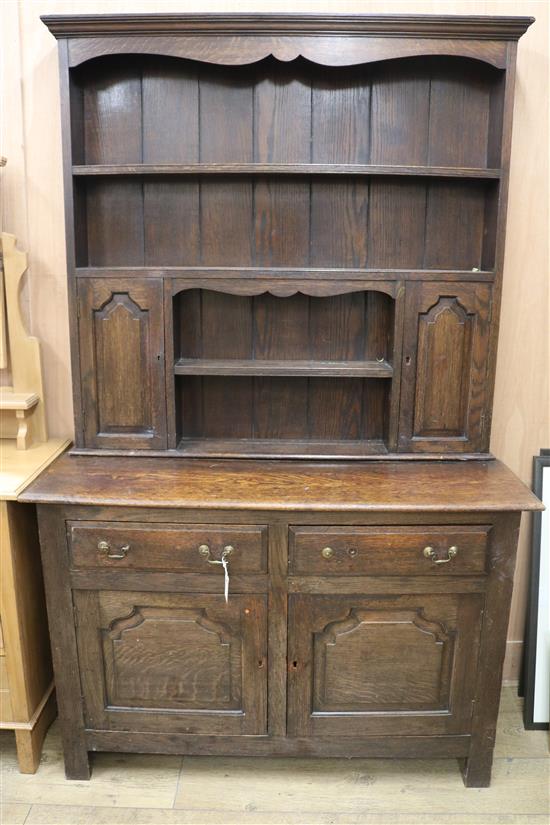A 1920s oak dresser with plate rack over W.120cm